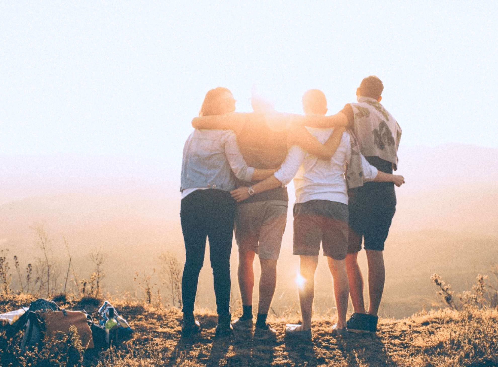 People standing together at sunrise